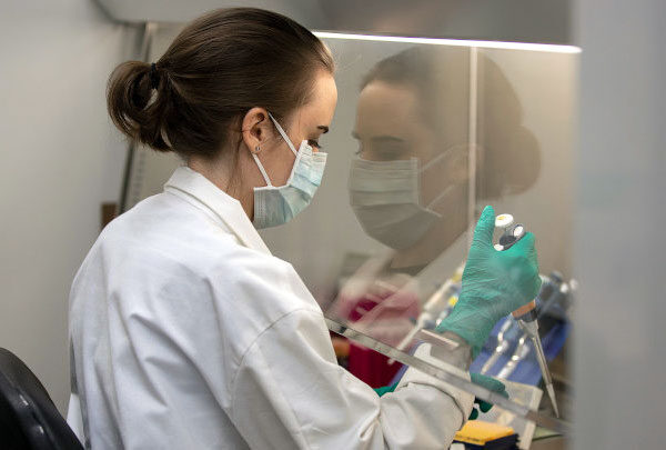Student Susan Zelasko working under a fume hood