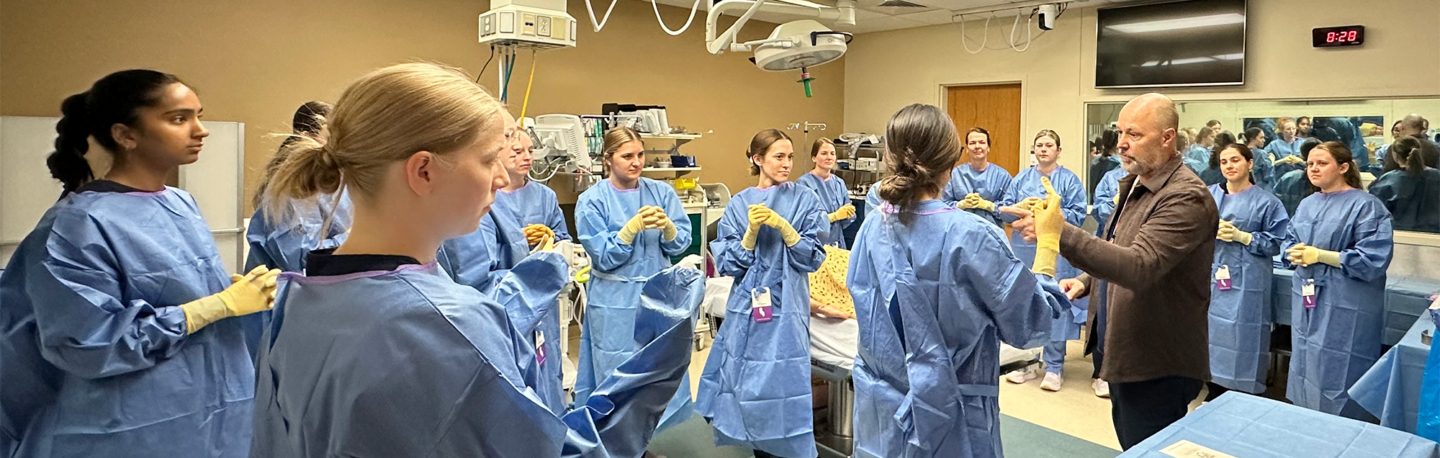 Students dressed in PPE gather in a group in a learning setting