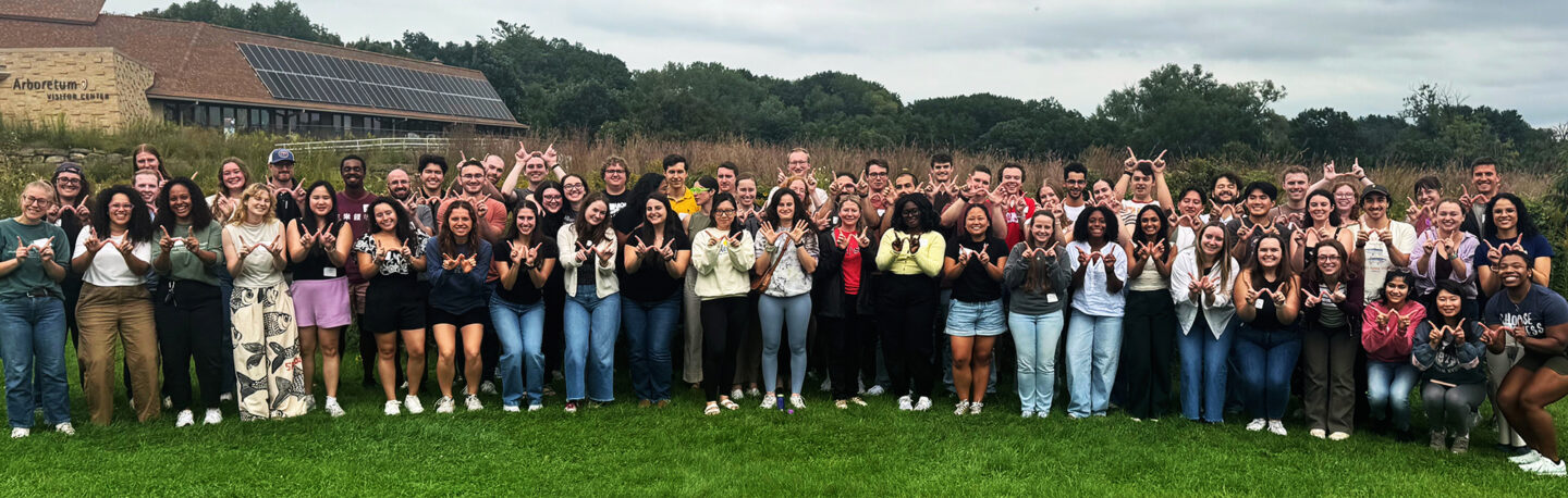 A large group of students smiling together outdoors