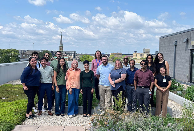 TRIUMPH students smile for a group photo in a rooftop garden