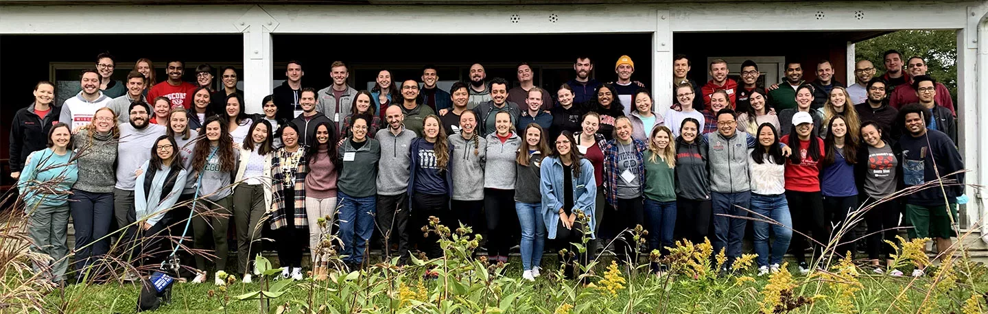 A large group of students smiling together outdoors