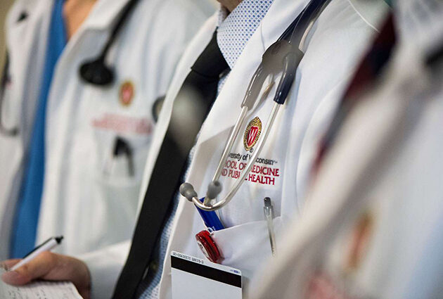 A close up of a UW School of Medicine and Public Heath white coat