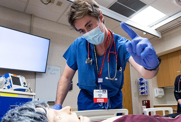 A medical student focusing on a simulated clinical task
