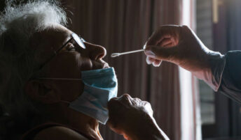 nursing home patient has nose swabbed for flu test