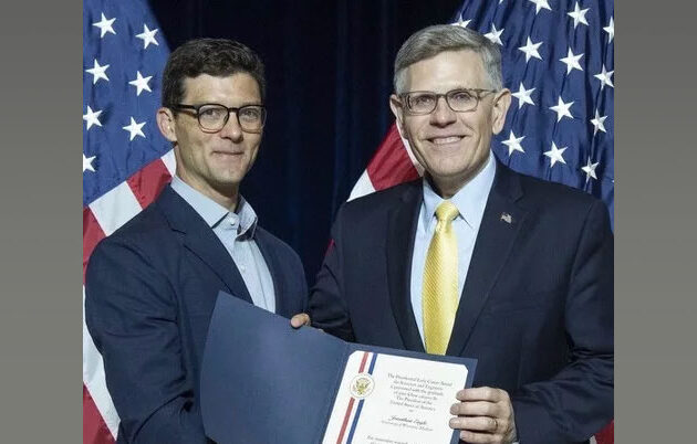 Jonathan Engle receiving an award