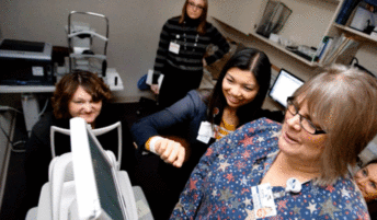 Dr. Yao Liu and staff at the Mile Bluff Medical Center in Mauston look at an image from an eye camera