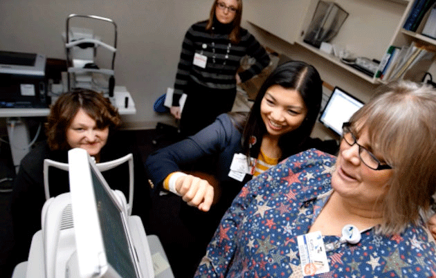 Dr. Yao Liu and staff at the Mile Bluff Medical Center in Mauston look at an image from an eye camera