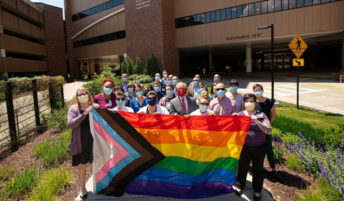Group of people holding LGBTQ+flag