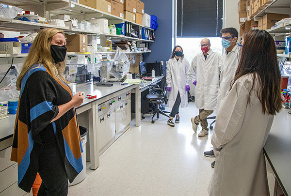 Group of MD-PhD students having a discussion in a classroom lab