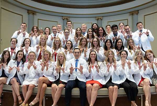 A large group of students in their white coats repping UW