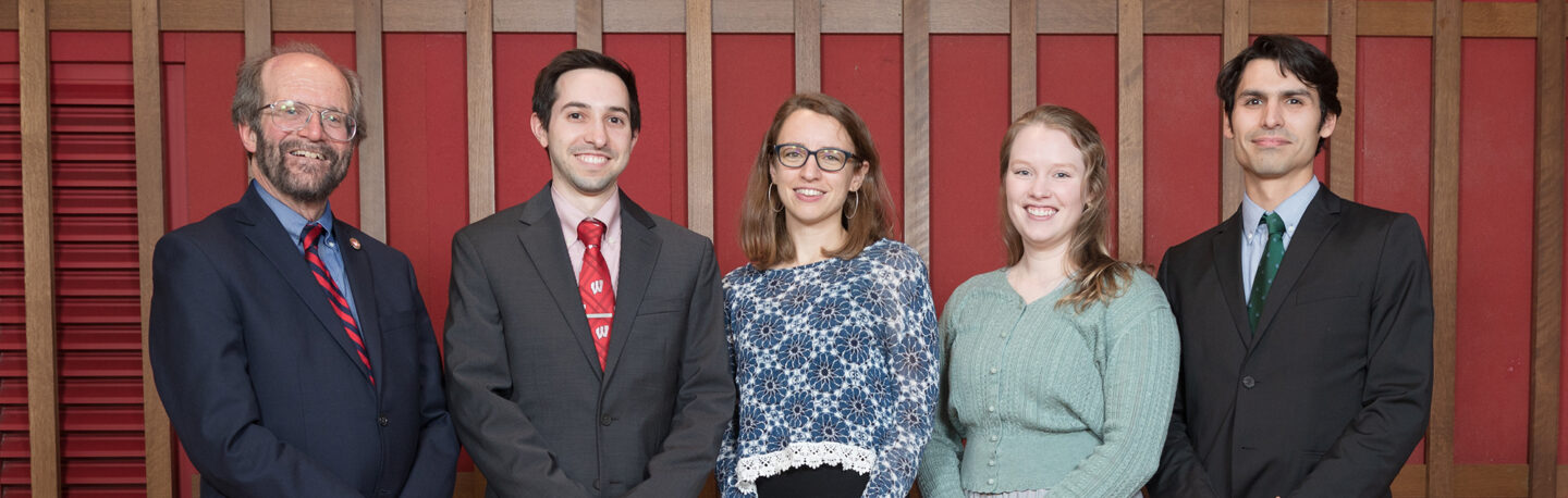 Students pose for a picture with the Dean at a formal attire event