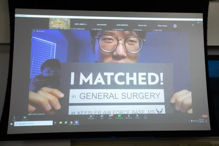 Richard Lee holds an "I Matched" sign