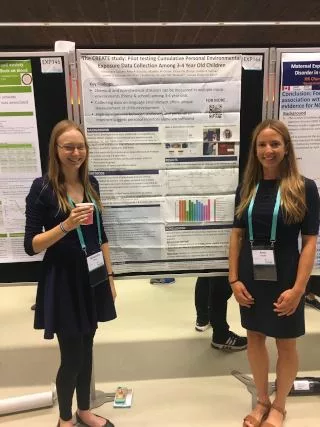 SHOW team members in front of a poster at ISEE conference